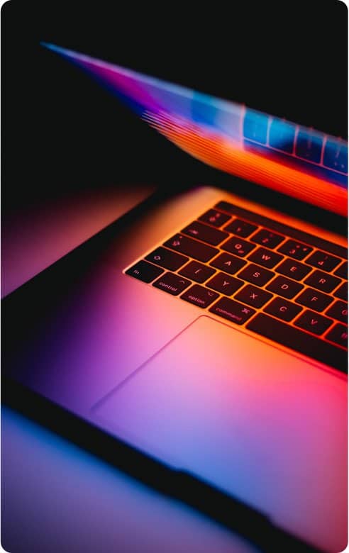 half open laptop in multicolour light